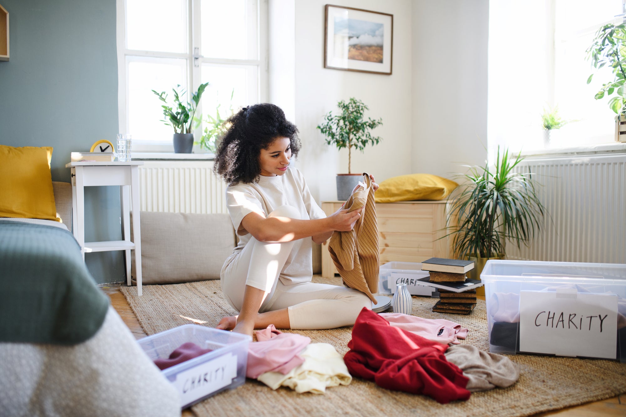 woman using a monthly cleaning schedule to clean her living room